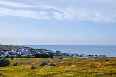 Scenic view of sea and buildings against sky