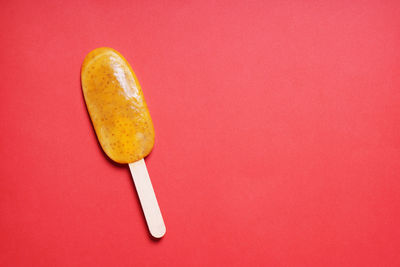 High angle view of apple against red background