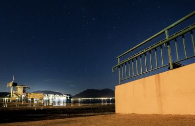 Illuminated building against clear sky at night