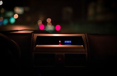 Close-up of dashboard in car at night