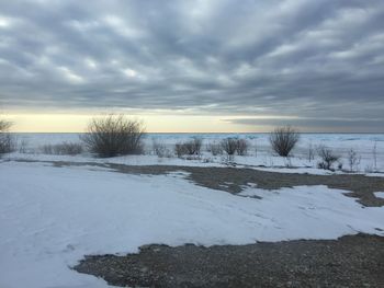 Snow on field against sky during winter