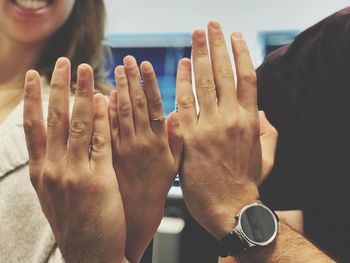 Close-up of cropped hands of people