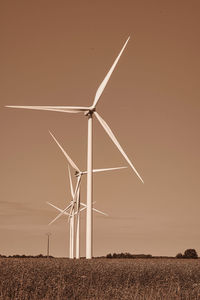 Windmill on field against sky