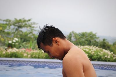 Portrait of shirtless boy in swimming pool