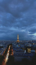 Illuminated buildings in city at dusk