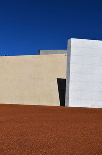 Buildings against clear blue sky