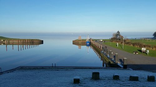 Scenic view of sea against clear blue sky