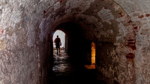 Silhouette of man in tunnel