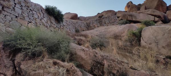 Rock formations on landscape against sky