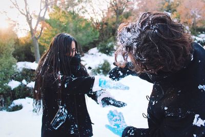 Two people playing with snow