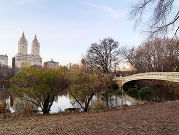 Arch bridge over river against buildings