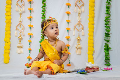 Adorable infant dressed as hindu god krishna on the occasion of janmashtami celebrated at india