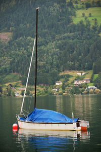 Boat moored on lake against mountain