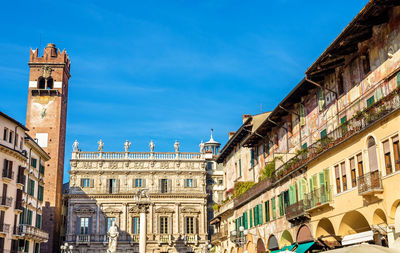 Buildings in city against blue sky