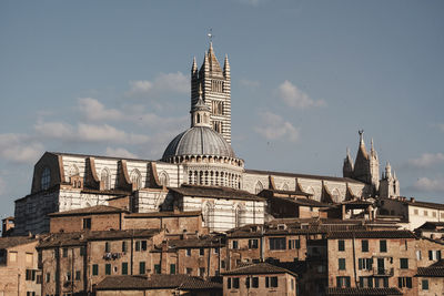 View of buildings in city against sky