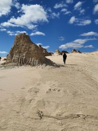 Full length of man on arid landscape against sky