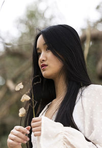 Chinese teenager with a flower in hand iv