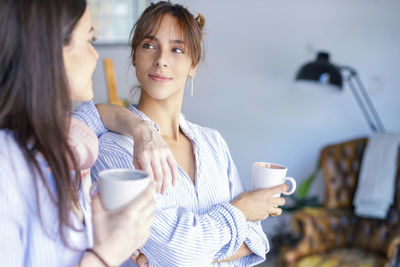 Woman holding coffee cup