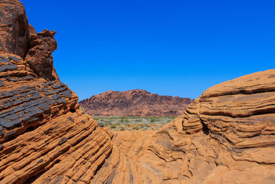 Rock formations in desert against blue sky