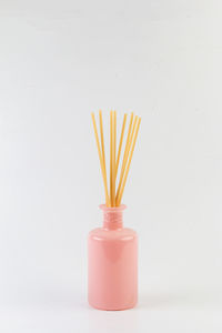 Close-up of wineglass on table against white background