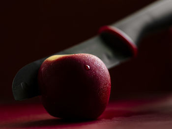 Close-up of apple on table against black background