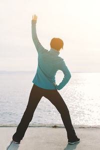 Man standing at beach against sky