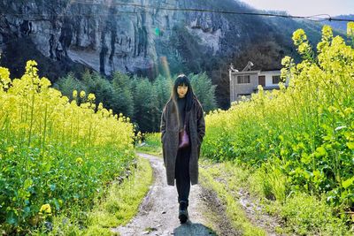 Woman standing by plants