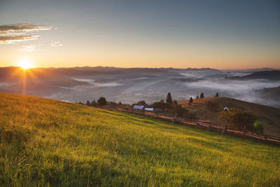 Scenic view of mountains against sky during sunrise