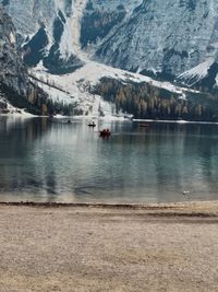 Scenic view of lake by snowcapped mountains