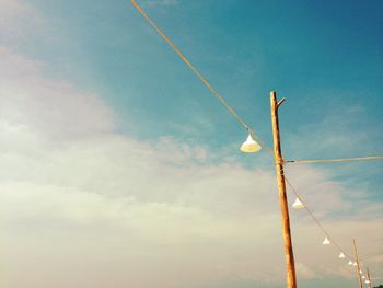 Low angle view of illuminated street light against sky