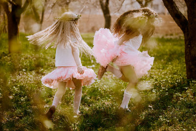 Low angle view of girls playing on field