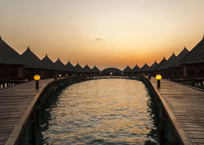 Silhouette of pier on sea