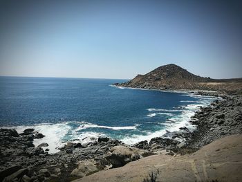 Scenic view of sea against clear blue sky