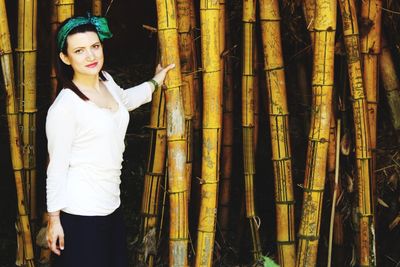 Portrait of woman standing in bamboo forest