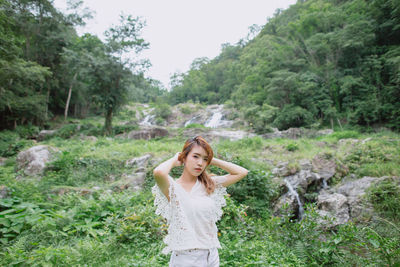 Young woman standing in a garden