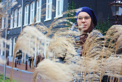 Beautiful young woman in city during winter