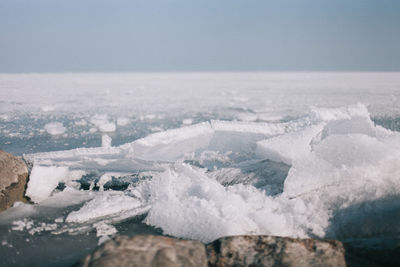 Close-up of frozen sea against sky