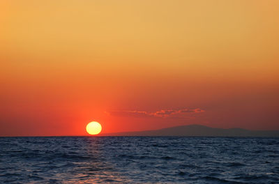 Scenic view of sea against romantic sky at sunset