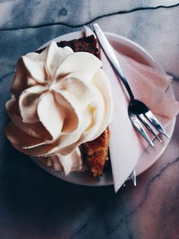 High angle view of whipped cream on apple pie served in plate on table