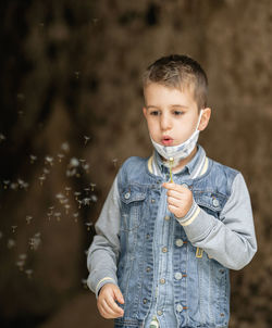 Portrait of boy standing outdoors