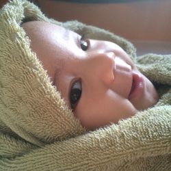 Portrait of cute baby lying on bed