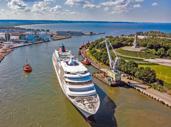 High angle view of sea by city against sky