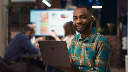 Portrait of man using laptop