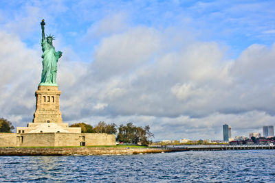 Statue of liberty against cloudy sky