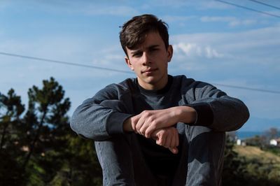 Portrait of young man standing on land