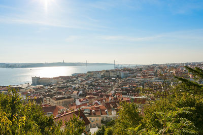 High angle view of townscape by sea against sky