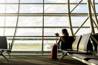 Woman sitting on chair in airport