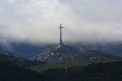 View of cross on mountain against sky