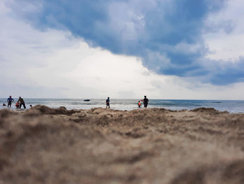 People on beach against sky