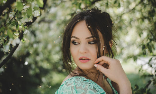 Close-up of young woman posing outdoors